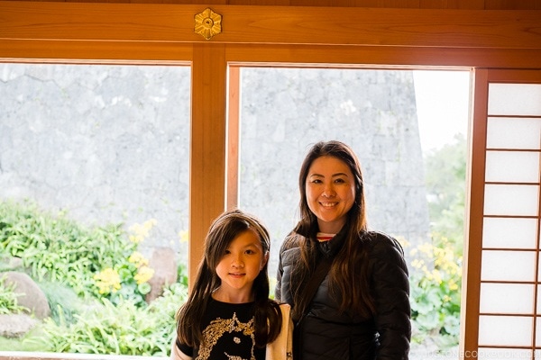 female and girl in front of a window