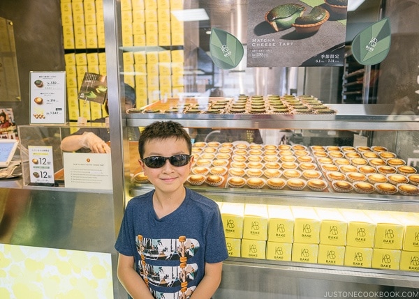 Just One Cookbook child in front of Bake Cheese Tart Lumine EST - Shinjuku Travel Guide | justonecookbook.com