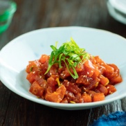 Spicy Tuna served in a bowl with scallion on top.