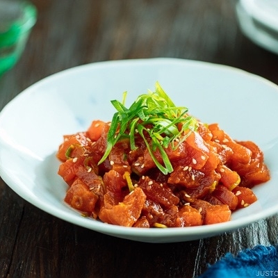 Spicy Tuna served in a bowl with scallion on top.