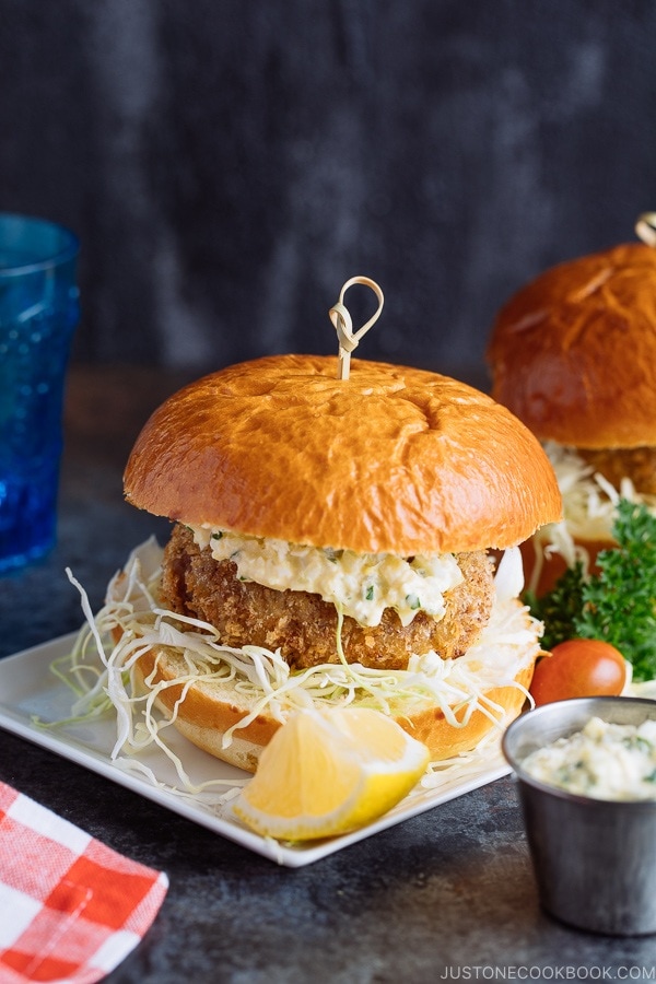 Menchi Katsu Sandwich is a ground meat patty coated with crispy panko and deep fried into golden brown. It is then topped with thinly sliced cabbage and homemade tartar sauce, and sandwiched in soft brioche buns.