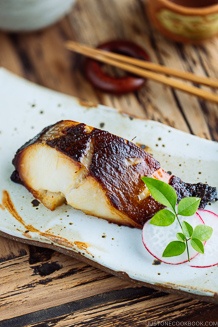 Beautifully charred Miso Cod (Black Cod with Miso) served on a white Japanese ceramic.