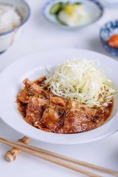 Pan Fried Ginger Pork Belly served with thinly shredded cabbage.