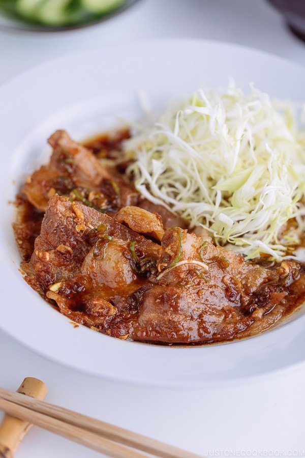 Pan Fried Ginger Pork Belly served with thinly shredded cabbage.