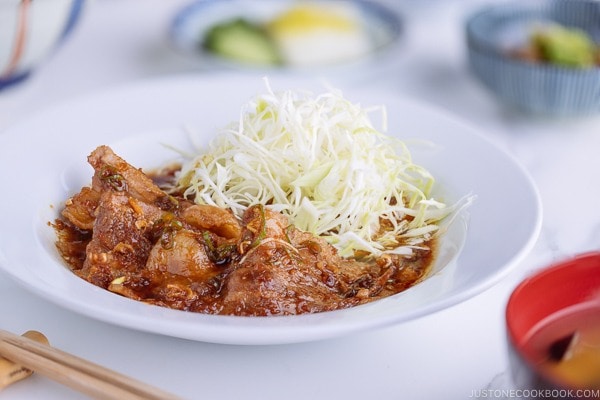 Pan Fried Ginger Pork Belly served with thinly shredded cabbage.