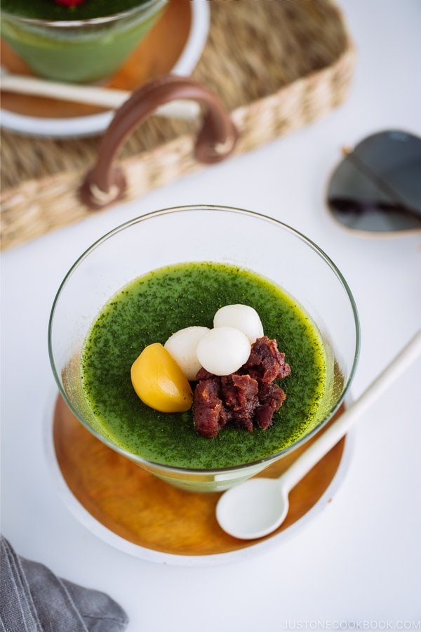 Matcha Vegan Panna Cotta served in a glass bowl, topped with mochi, red bean paste, and candied chestnut.