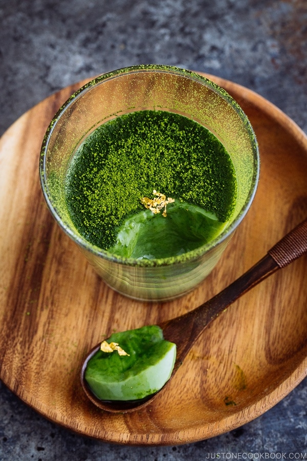 Matcha Vegan Panna Cotta served in a glass bowl, topped with gold flakes!