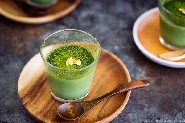 Matcha Vegan Panna Cotta served in a glass bowl, topped with gold flakes!