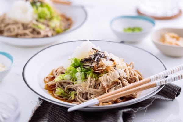 Oroshi soba served in dashi based sauce topped with grated daikon, bonito flakes, and scallion.