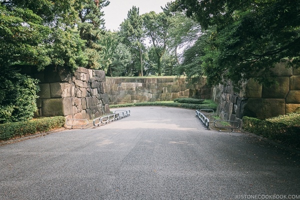 walkway surrounded by stone walls - The East Gardens of the Imperial Palace Guide | www.justonecookbook.com