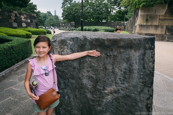 Just One Cookbook child in front of large stone to built castle wall - The East Gardens of the Imperial Palace Guide | www.justonecookbook.com