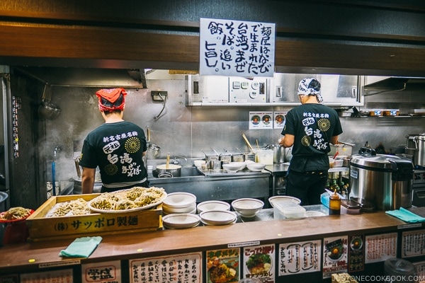 chefs cooking behind the counter at Menya Haruka - Akihabara Travel Guide | www.justonecookbook.com