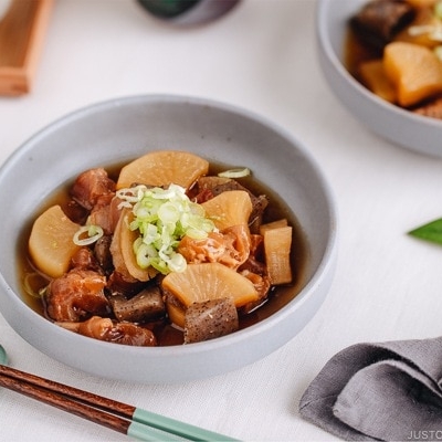 A grey dish containing Japanese beef tendon stew.