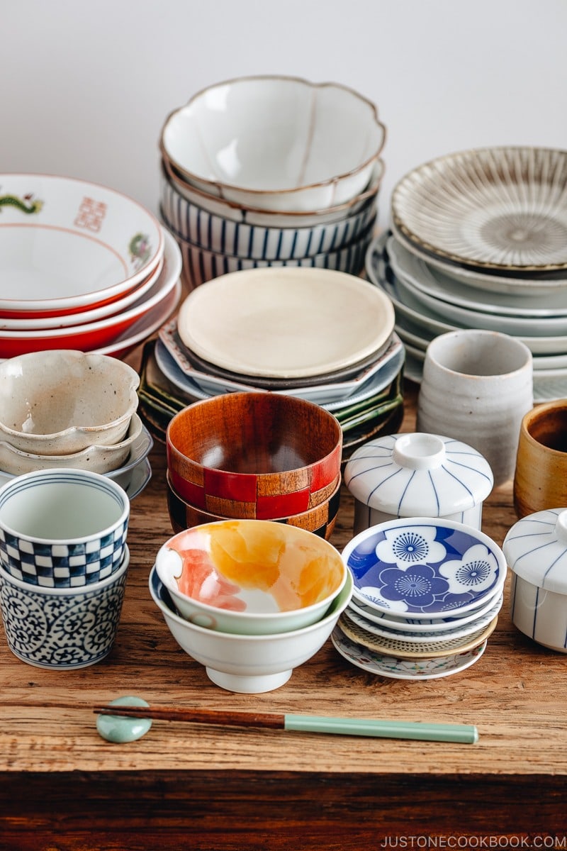 Selection of Japanese tableware including plates and bowls on a table.