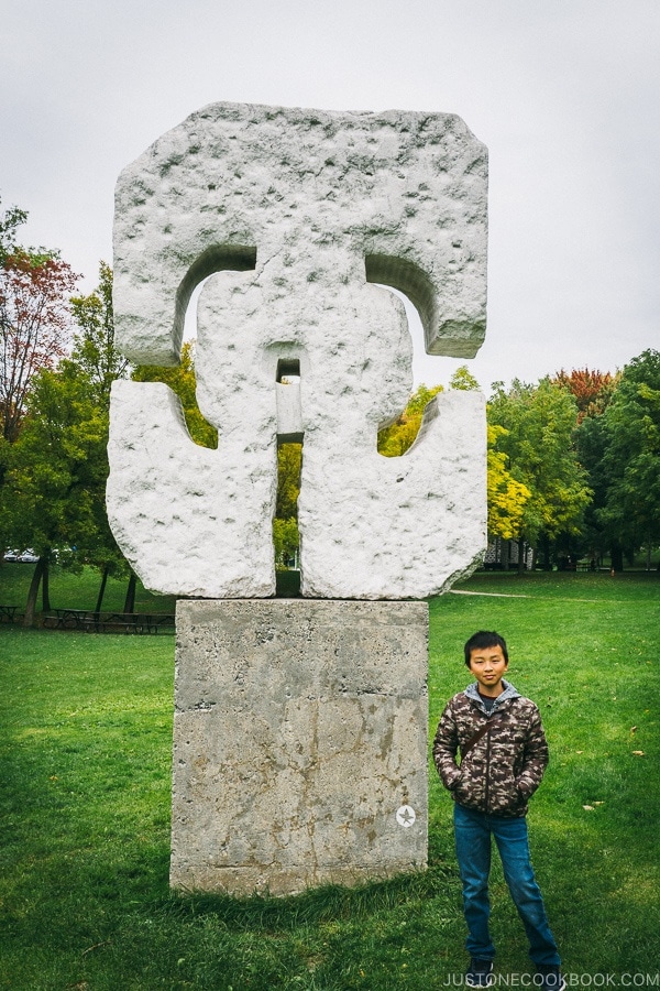 child standing next to sculpture at Mount Royal Park - Montreal Travel Guide | www.justonecookbook.com