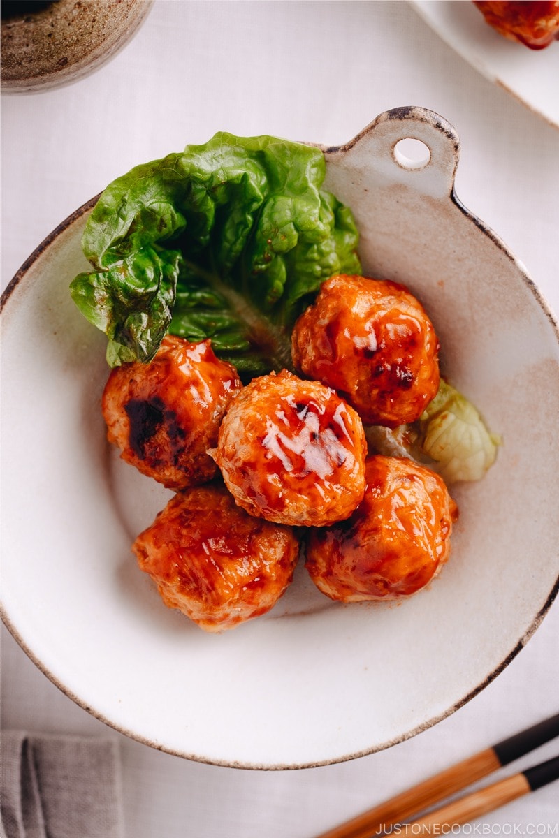A white dish containing Chicken Meatballs with Sweet and Sour Sauce.
