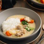 A gray bowl containing Japanese Cream Stew (White Stew) with chicken and vegetables in a savory thick white sauce.