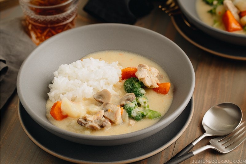 A gray bowl containing Japanese Cream Stew (White Stew) with chicken and vegetables in a savory thick white sauce.