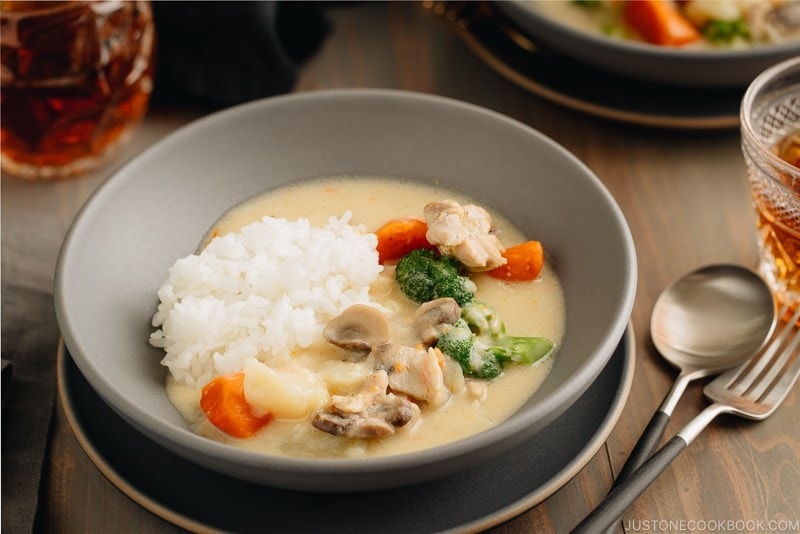 A gray bowl containing Japanese Cream Stew (White Stew) with chicken and vegetables in a savory thick white sauce.
