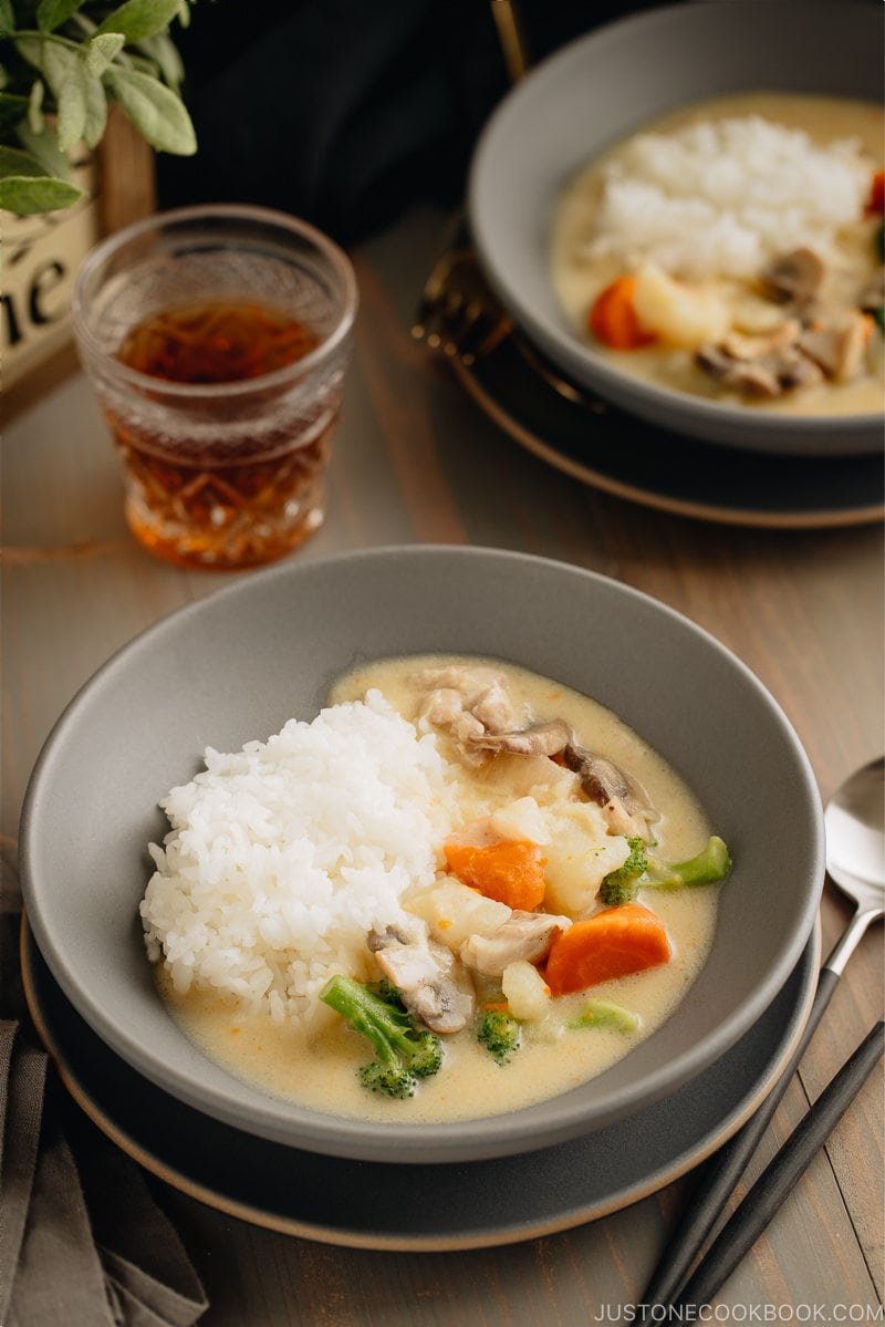 A gray bowl containing Japanese Cream Stew (White Stew) with chicken and vegetables in a savory thick white sauce.