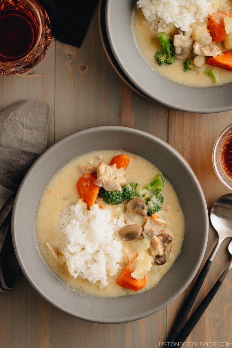 A gray bowl containing Japanese cream stew (white stew) with chicken and vegetables in a tasty thick white sauce.
