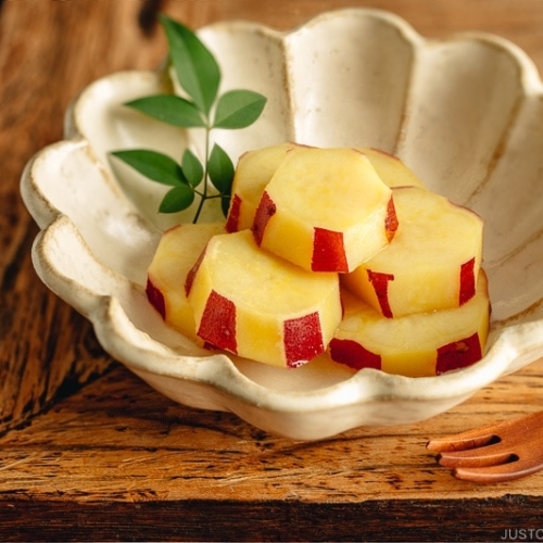 Fluted bowl containing Simmered Japanese Sweet Potatoes with Lemon.