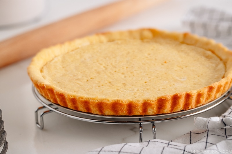 Sweet tart crust on a wire rack.