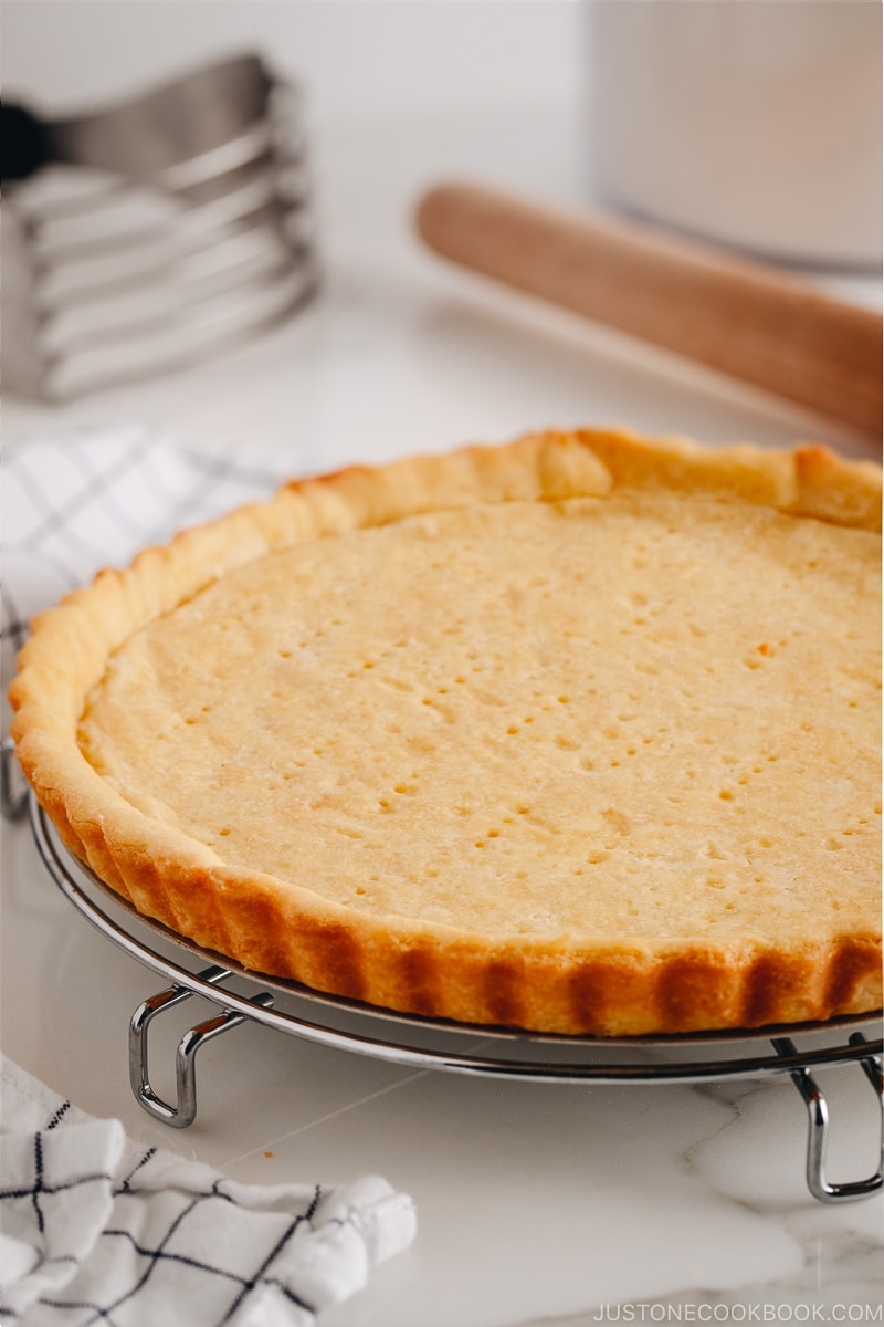 Sweet tart crust on a wire rack.