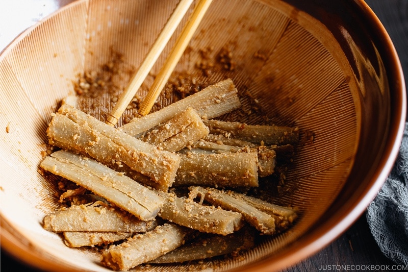 A Japanese mortar (suribachi) containing Pounded Burdock Root with Sesame Sauce (Tataki Gobo).