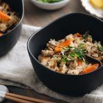 Black ceramic bowls containing Japanese Mixed Rice (Takikomi Gohan).