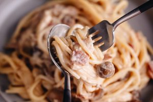 Creamy Mushroom and Bacon Pasta on a grey plate.