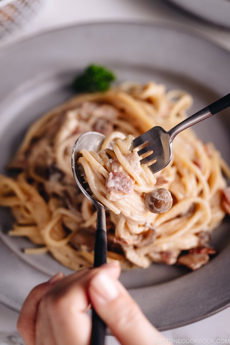 Creamy Mushroom and Bacon Pasta on a grey plate.