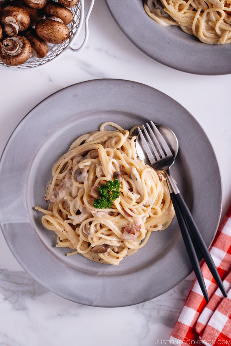 Creamy Mushroom and Bacon Pasta on a grey plate.