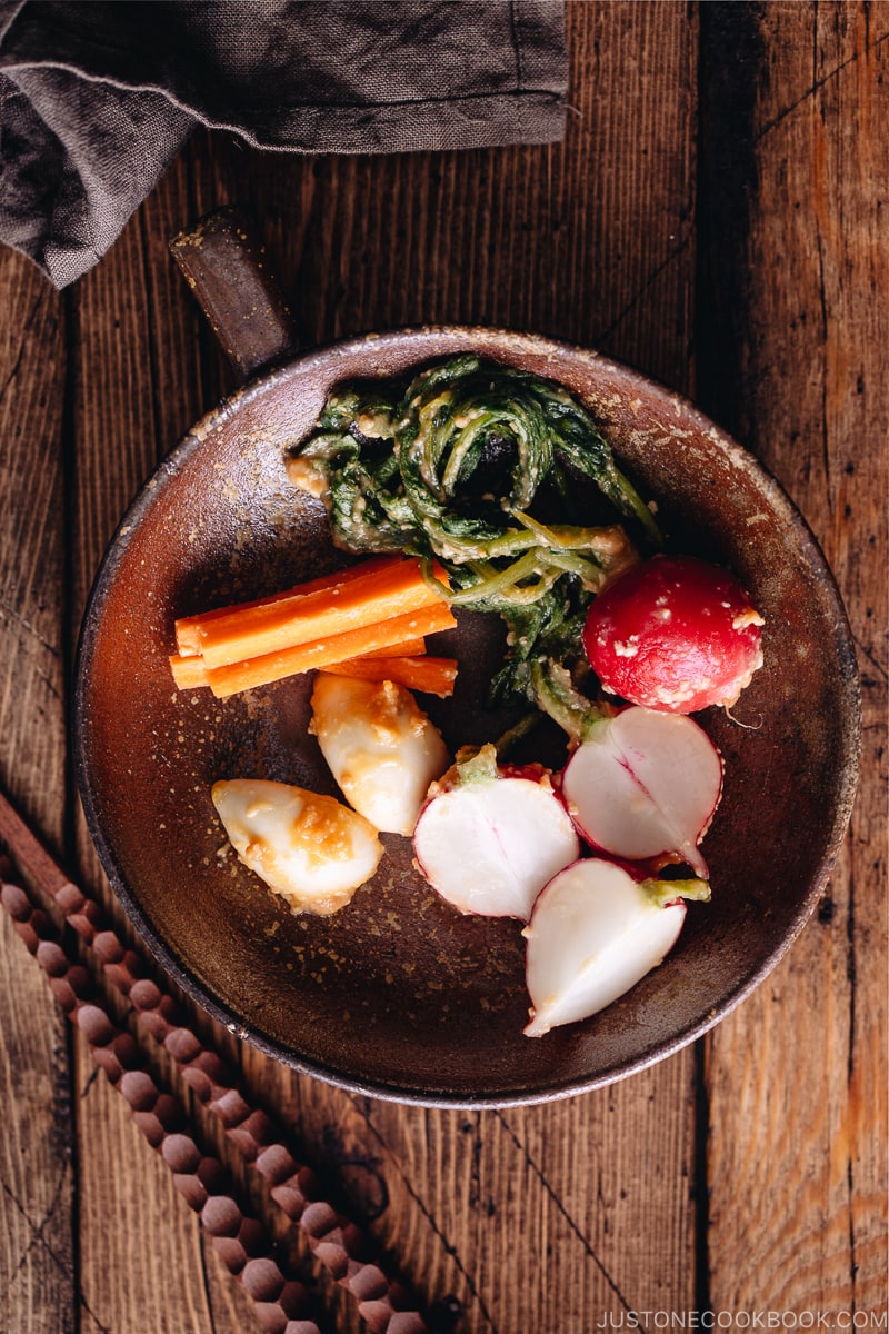 Carrot, radish, and garlic misozuke (miso pickles) in a brown ceramic.