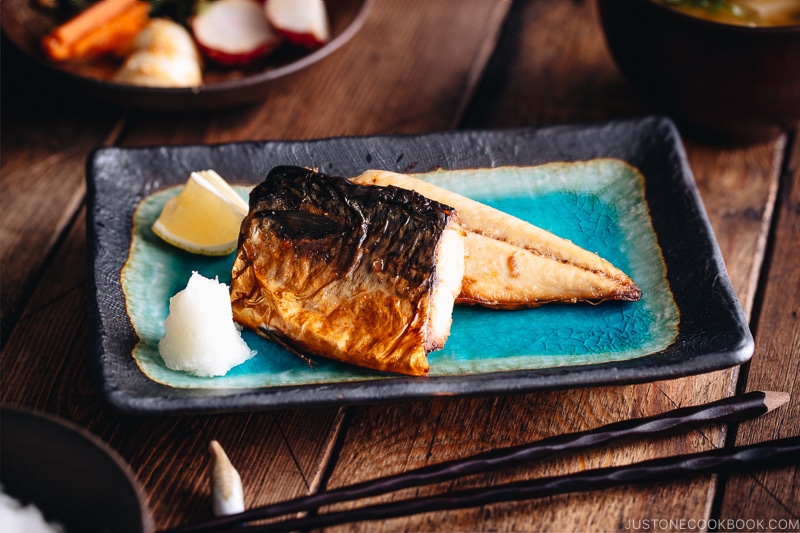 Grilled mackerel (saba shioyaki) on a Japanese style plate, served with miso soup, rice and pickles.