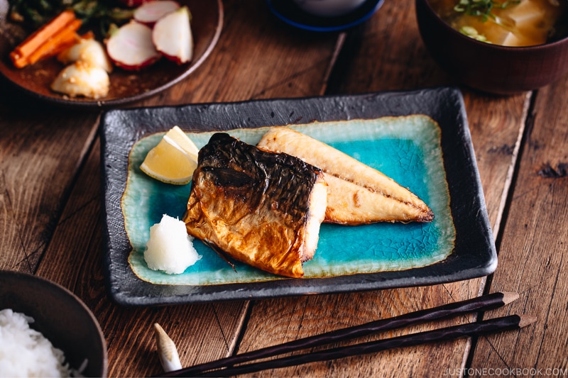 Grilled mackerel (saba shioyaki) on a Japanese style plate, served with miso soup, rice and pickles.