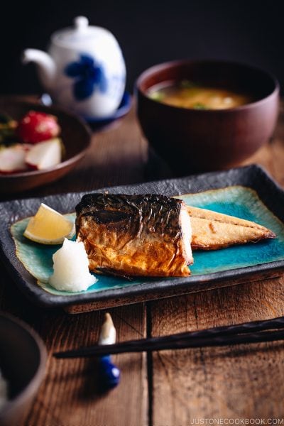 Grilled mackerel (saba shioyaki) on a Japanese style plate, served with miso soup, rice and pickles.
