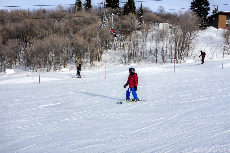 child skiing down the hill at Snowbasin Resort - Ski Vacation Planning in Utah | www.justonecookbook.com