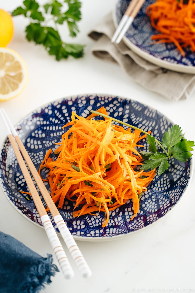 Carrot salad on a blue plate.