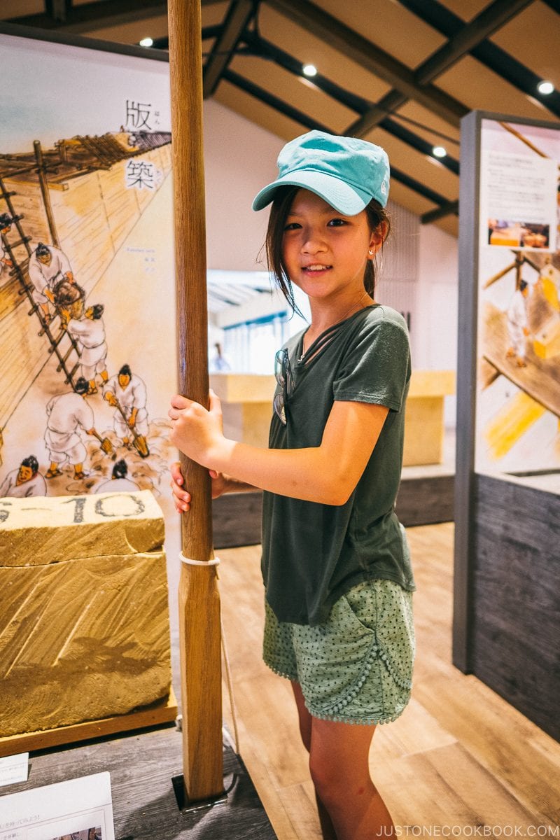 child holding tool used for reconstruction of Nara Palace - Nara Guide: Historical Nara Temples and Shrine | www.justonecookbook.com