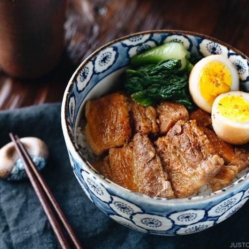 Pressure cooker kakuni (Instant Pot Japanese Pork Belly) served over rice along with eggs and greens in donburi bowl.