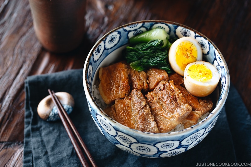 Pressure cooker kakuni (Instant Pot Japanese Pork Belly) served over rice along with eggs and greens in donburi bowl.