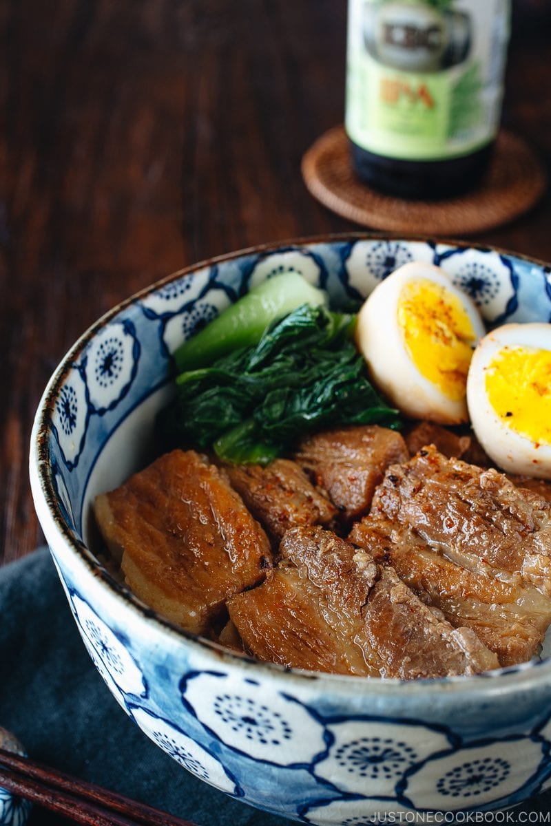 Pressure cooker kakuni (Instant Pot Japanese Pork Belly) served over rice along with eggs and greens in donburi bowl.