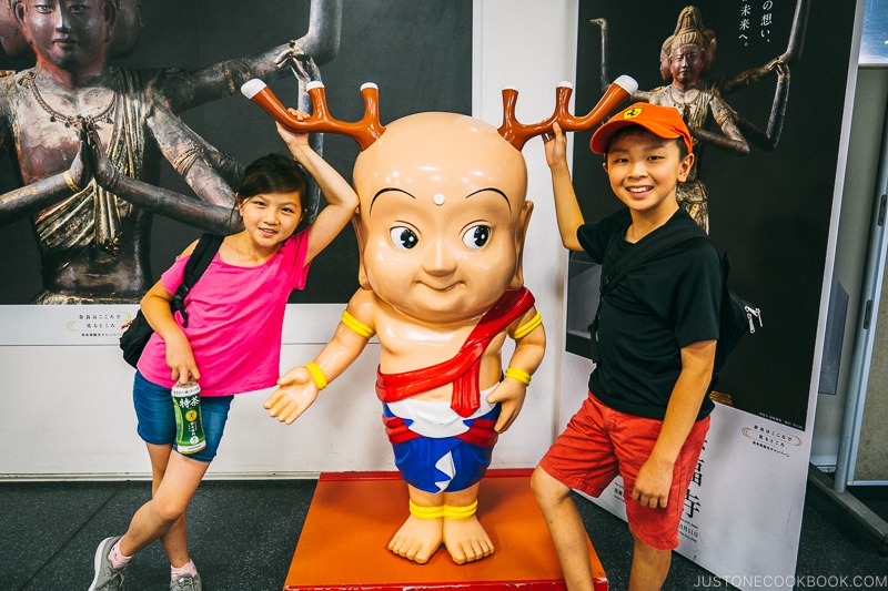 children posing next to statue of Sento-kun - Nara Guide: Things to do in Nara | www.justonecookbook.com