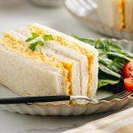 Tamago Sando - Japanese Egg Salad Sandwich on a plate along with salad.