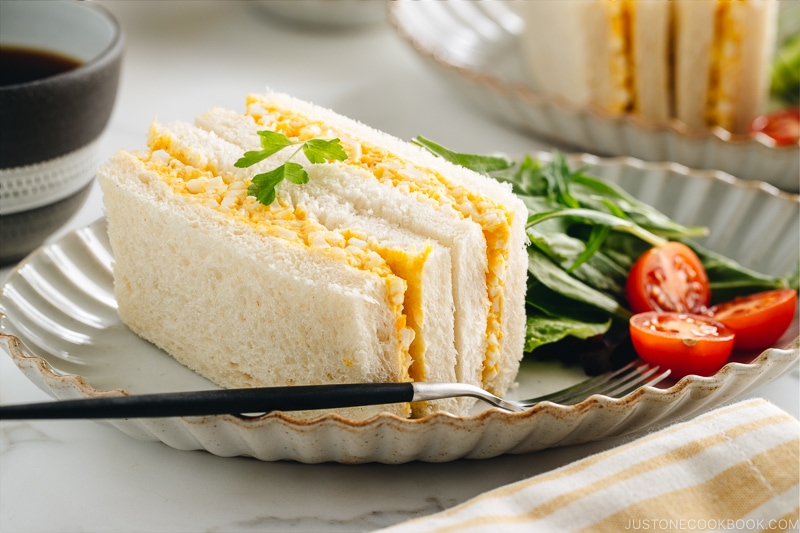 Tamago Sando - Japanese Egg Salad Sandwich on a plate along with salad.