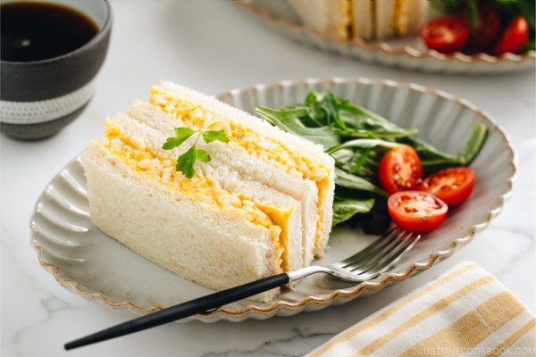 Tamago Sando - Japanese Egg Salad Sandwich on a plate along with salad.