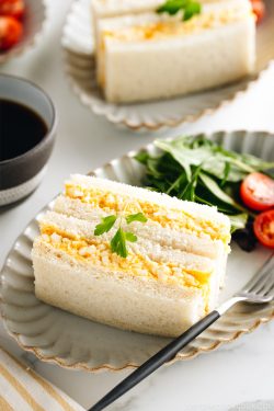 Tamago Sando - Japanese Egg Salad Sandwich on a plate along with salad.