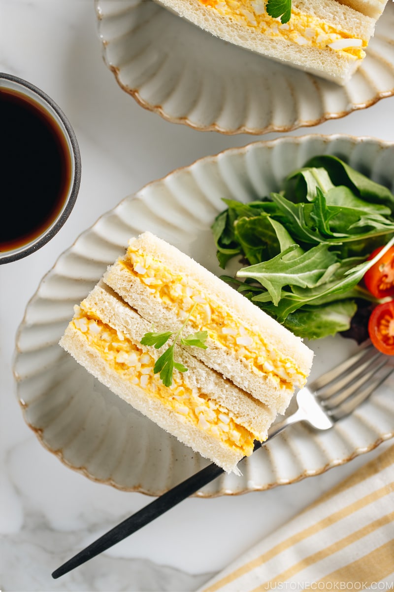 Tamago Sando - Japanese Egg Salad Sandwich on a plate along with salad.