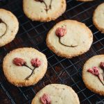 Cherry blossom cookies on a wire rack.